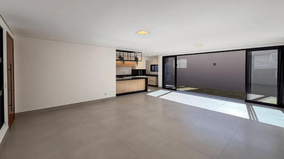 Living com grande porta de vidro para a área externa